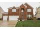 Charming brick home with a well-manicured lawn and a two-car garage at 8744 N Aspen Way, McCordsville, IN 46055