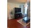 Cozy living room featuring hardwood floors, a fireplace, and a large window for plenty of natural light at 8744 N Aspen Way, McCordsville, IN 46055