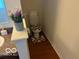 Neat bathroom featuring a standard toilet, patterned rug, and decorative floral arrangement at 8744 N Aspen Way, McCordsville, IN 46055
