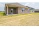 View of the backyard, showing the covered patio and brick exterior at 895 Saddlebrook Farms Blvd, Whiteland, IN 46184