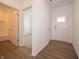 Bright entryway with wood-look flooring, a front door with glass accents, and a nearby bathroom at 895 Saddlebrook Farms Blvd, Whiteland, IN 46184