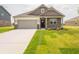 Charming single-Gathering home featuring a brick facade, well-manicured lawn, and an attached two-car garage at 895 Saddlebrook Farms Blvd, Whiteland, IN 46184