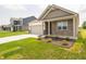 Attractive home showcases a mix of brick and siding, a neat lawn, and an attached two-car garage at 895 Saddlebrook Farms Blvd, Whiteland, IN 46184