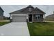 Charming single-story home featuring brick and siding exterior and attached two car garage at 895 Saddlebrook Farms Blvd, Whiteland, IN 46184
