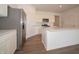 Modern kitchen features a large island, stainless steel appliances, and sleek white cabinetry at 895 Saddlebrook Farms Blvd, Whiteland, IN 46184