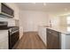 Modern kitchen features stainless steel appliances and a large island with a sink at 895 Saddlebrook Farms Blvd, Whiteland, IN 46184