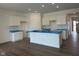 Bright kitchen with recessed lighting, white cabinets, and island with stainless steel sink at 895 Saddlebrook Farms Blvd, Whiteland, IN 46184
