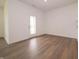 Bright living room featuring wood-look floors and a glass paneled door to the outside at 895 Saddlebrook Farms Blvd, Whiteland, IN 46184