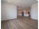 Open-concept living room showcasing hardwood flooring and seamless flow to the kitchen at 895 Saddlebrook Farms Blvd, Whiteland, IN 46184