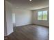Open-concept living room with hardwood floors and a large window providing ample natural light at 895 Saddlebrook Farms Blvd, Whiteland, IN 46184