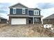 Two-story home with blue siding, brick facade, white trim, and an attached two-car garage. Ready to be lived in at 905 Saddlebrook Farms Blvd, Whiteland, IN 46184