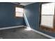 A bedroom featuring blue walls, with two windows that offer natural light at 917 W 27Th St, Indianapolis, IN 46208