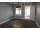 A bedroom featuring blue walls with natural lighting, and an open doorway to another room at 917 W 27Th St, Indianapolis, IN 46208