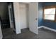 A bedroom with an open closet, featuring neutral carpet and bright window at 917 W 27Th St, Indianapolis, IN 46208