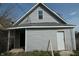 Back of a home showing the gray siding and a white door at 917 W 27Th St, Indianapolis, IN 46208