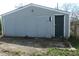 Exterior view of the detached garage with boarded up door at 917 W 27Th St, Indianapolis, IN 46208