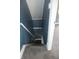 Hallway features staircase with carpeted steps and blue paneling on the walls at 917 W 27Th St, Indianapolis, IN 46208