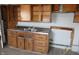 This kitchen features wood cabinets, a stainless steel sink, and a neutral countertop at 917 W 27Th St, Indianapolis, IN 46208