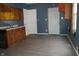 Outdated kitchen features wood cabinets, a sink and wood look floors at 917 W 27Th St, Indianapolis, IN 46208