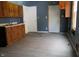 Outdated kitchen features wood cabinets, a sink and wood look floors at 917 W 27Th St, Indianapolis, IN 46208