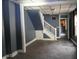 Empty living room featuring a staircase and doorway at 917 W 27Th St, Indianapolis, IN 46208