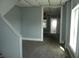 This room has neutral carpeting, a ceiling fan, and a view to the adjacent room and entryway at 917 W 27Th St, Indianapolis, IN 46208