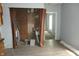 The room features wood floors and bare brick wall space exposed with brown curtain rods in place at 917 W 27Th St, Indianapolis, IN 46208