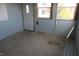 Sunroom with tile flooring, light blue walls, and a back door entrance at 917 W 27Th St, Indianapolis, IN 46208
