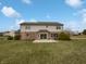 Expansive backyard featuring a well-maintained lawn, a brick exterior, and a cozy patio area at 9237 Stones Ferry Pl, Indianapolis, IN 46278