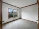 A cozy room with a window showing outdoor views, carpeted flooring, and wood trim adds warmth and detail at 9237 Stones Ferry Pl, Indianapolis, IN 46278
