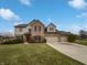 Charming two-story home with a three-car garage, brick accents, and a well-manicured lawn at 9237 Stones Ferry Pl, Indianapolis, IN 46278