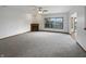 Spacious living room showcasing a fireplace and a large window offering plenty of natural light at 9237 Stones Ferry Pl, Indianapolis, IN 46278