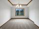 A spacious living room with large window, carpeted flooring, and decorative tray ceiling at 9237 Stones Ferry Pl, Indianapolis, IN 46278