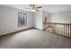 Open loft area with natural light, wooden railing, and views overlooking the lower level at 9237 Stones Ferry Pl, Indianapolis, IN 46278