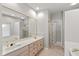 Large bathroom with a double sink vanity and a large mirror at 9544 Huntington Ln, Indianapolis, IN 46260