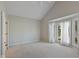 Spacious bedroom with plush carpet, a ceiling fan, and a bright bay window at 9544 Huntington Ln, Indianapolis, IN 46260