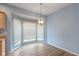 Eat-in kitchen with wood floor, bay windows, and custom lighting at 9544 Huntington Ln, Indianapolis, IN 46260