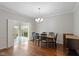 Formal dining room with hardwood floors, chandelier, and access to a sunroom at 9544 Huntington Ln, Indianapolis, IN 46260