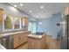 Well-lit kitchen featuring a center island, ample counter space, and a stainless-steel refrigerator at 9544 Huntington Ln, Indianapolis, IN 46260