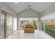 Bright sunroom with tiled floors and large windows offering serene backyard views at 9544 Huntington Ln, Indianapolis, IN 46260