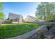 Spacious backyard with a lush green lawn, charming patio, and gravel pathway leading through the yard at 9705 Shasta Dr, Fishers, IN 46038