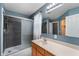 Bathroom with a large mirror, glass shower, and modern fixtures at 9705 Shasta Dr, Fishers, IN 46038