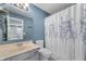 Bathroom featuring a vanity, toilet, mirror, and shower with patterned curtain at 9705 Shasta Dr, Fishers, IN 46038