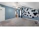 Bedroom featuring a ceiling fan, hexagon wall decorations, and an ensuite bathroom at 9705 Shasta Dr, Fishers, IN 46038
