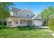 Beautiful home exterior features a covered porch, attached garage, and lush green lawn at 9705 Shasta Dr, Fishers, IN 46038