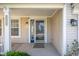Inviting covered front porch with a decorative glass front door and stylish exterior lighting at 9705 Shasta Dr, Fishers, IN 46038