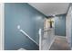 Upstairs hallway featuring blue walls and a white banister at 9705 Shasta Dr, Fishers, IN 46038