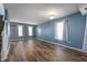 Bright living room featuring hardwood floors, large windows, and neutral paint at 9705 Shasta Dr, Fishers, IN 46038