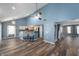 Open-concept living room flowing into the kitchen, featuring a vaulted ceiling and hardwood floors at 9705 Shasta Dr, Fishers, IN 46038