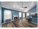 Inviting living room with fireplace, vaulted ceiling, hardwood floors, and access to the kitchen at 9705 Shasta Dr, Fishers, IN 46038